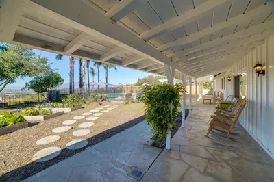 a porch of a house with a patio at Spacious Riverside Farmhouse, Perfectly Located in Riverside