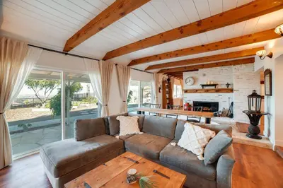 a living room with a couch and a table at Spacious Riverside Farmhouse, Perfectly Located in Riverside