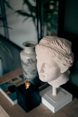 a statue of a head on a table next to a vase at Luca's Tree Flat - Los Angeles California in Studio City