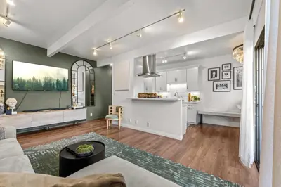 a living room with a couch and a kitchen at Luca's Tree Flat - Los Angeles California in Studio City