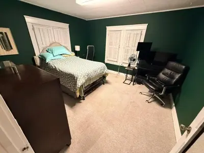 a bedroom with green walls and a bed and a desk at Larchmont 1875 sq ft house 3 bed 2 bathroom in Los Angeles
