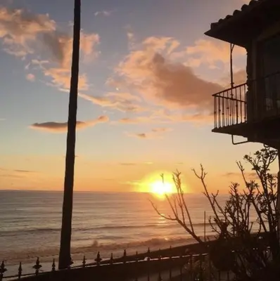 a sunset over the ocean from a beach at Villa Porto Marina - Oceanfront Living in Castellammare