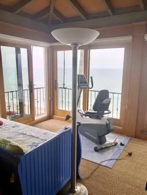 a bedroom with a bed and a desk and a chair at Villa Porto Marina - Oceanfront Living in Castellammare
