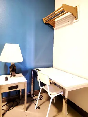 a desk with a lamp and a chair in a room at AVAION HOTEL LAX SoFi STADIUM in Inglewood
