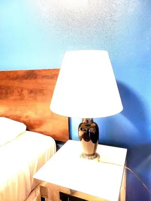 a lamp on a table next to two beds at AVAION HOTEL LAX SoFi STADIUM in Inglewood