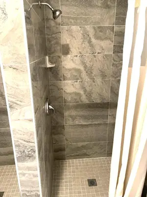 a shower with a glass door in a bathroom at AVAION HOTEL LAX SoFi STADIUM in Inglewood