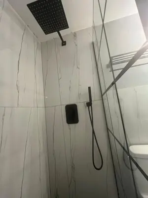 a white bathroom with a shower and a toilet at Minimalist Room in Buena Park in Buena Park