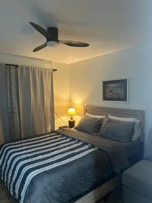 a bedroom with a bed with a ceiling fan at Minimalist Room in Buena Park in Buena Park