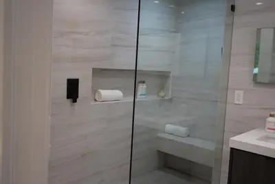 a bathroom with a glass shower with a sink at The Hollywood House in Los Angeles