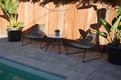 a patio with two chairs and a table next to a fence at The Hollywood House in Los Angeles