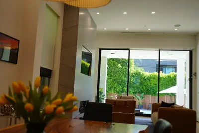 a dining room with a table with a vase of flowers at The Hollywood House in Los Angeles