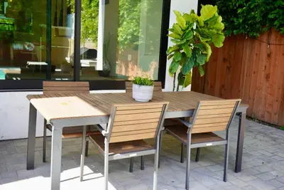 a wooden table and chairs on a patio at The Hollywood House in Los Angeles