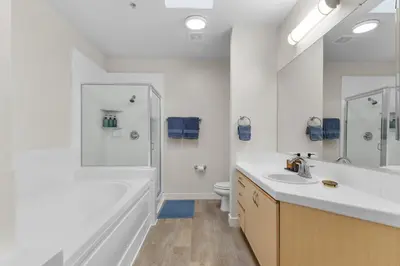 a bathroom with a sink and a tub and a toilet at The Nautilus Waterfront Retreat Marina View, Pool Sauna Gym Jacuzzi in Los Angeles