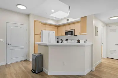 a kitchen with a white refrigerator and a counter at The Nautilus Waterfront Retreat Marina View, Pool Sauna Gym Jacuzzi in Los Angeles