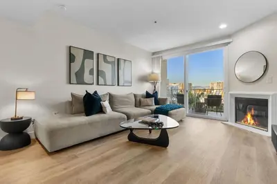 a living room with a couch and a fireplace at The Nautilus Waterfront Retreat Marina View, Pool Sauna Gym Jacuzzi in Los Angeles