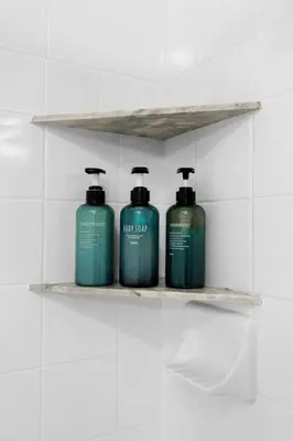 three green bottles on a shelf in a bathroom at The Nautilus Waterfront Retreat Marina View, Pool Sauna Gym Jacuzzi in Los Angeles