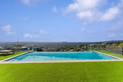 a large swimming pool with a view of a city at Hollywood Hills 6BR Luxury Home w Pool, Theater & Panoramic Views in Los Angeles