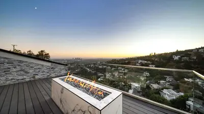 a patio with a fire pit on a roof at Hollywood Hills 6BR Luxury Home w Pool, Theater & Panoramic Views in Los Angeles