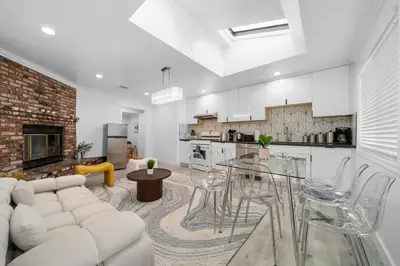 a living room with a white couch and a table at Marbella Lane - Serene and Pristine 2BR Home in West Covina