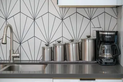 a kitchen counter with three metal kettles on a counter top at Marbella Lane - Serene and Pristine 2BR Home in West Covina