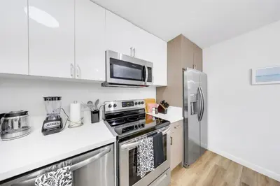 a kitchen with white cabinets and a stainless steel refrigerator at Oneluxstay Near Redondo Beach in Redondo Beach