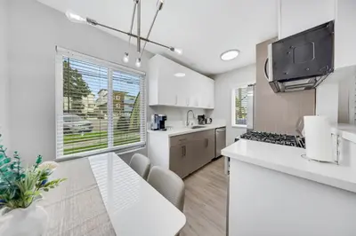 a kitchen with white counters and a dining table at Oneluxstay Near Redondo Beach in Redondo Beach