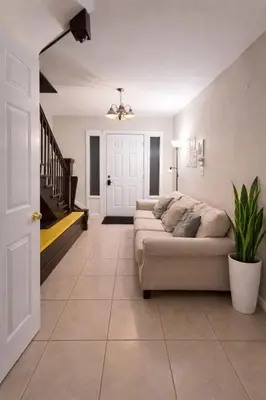 a living room with a couch and a staircase at Hollywood Comfort Vibe LA in Los Angeles