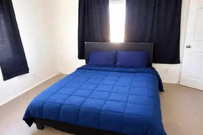 a blue bed with blue pillows in a bedroom at Hollywood Comfort Vibe LA in Los Angeles