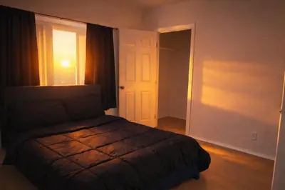 a bedroom with a bed and an open door at Hollywood Comfort Vibe LA in Los Angeles