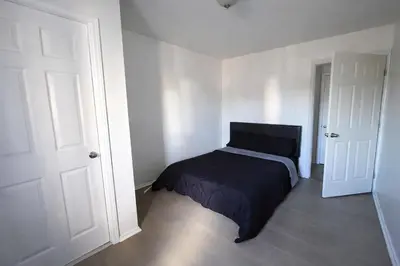 a bedroom with a bed with a black blanket at Hollywood Comfort Vibe LA in Los Angeles