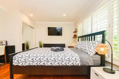 a bedroom with a bed with a television on the wall at Large Room with Private Entrance in Beverly Hills - BRB1 in Los Angeles