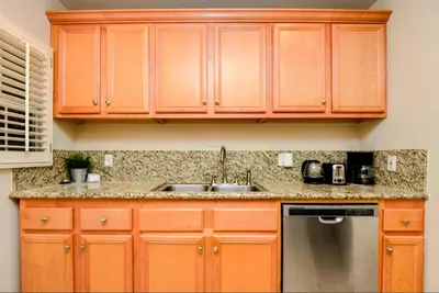 a kitchen with wooden cabinets and a sink at Large Room with Private Entrance in Beverly Hills - BRB1 in Los Angeles