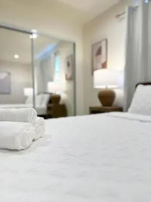 a hotel room with a bed with towels on it at 2BR Bohemian Haven Near Walk of Fame - BR6 - BUR in Burbank
