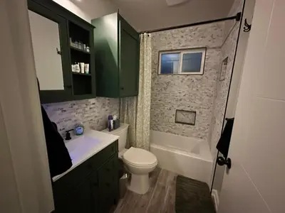 a bathroom with a toilet and a sink and a tub at No Ho Casita in North Hollywood