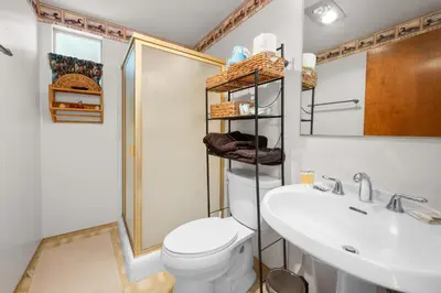 a bathroom with a toilet and a sink and a mirror at Lakeview Bear Cubs Den - Walk to Lake, Close to Slopes in Big Bear Lake