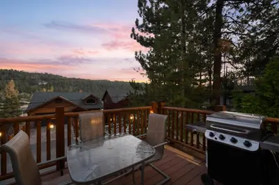 a patio with a table and a grill on a deck at Lakeview Bear Cubs Den - Walk to Lake, Close to Slopes in Big Bear Lake