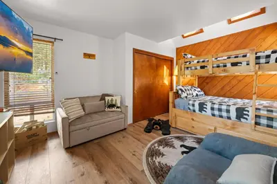 a living room with a bed and a couch at Lakeview Bear Cubs Den - Walk to Lake, Close to Slopes in Big Bear Lake