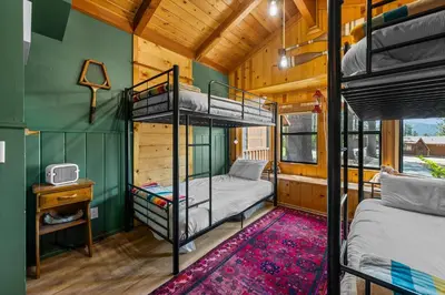 a bedroom with bunk beds in a tiny house at Colibri Cabin - Walk to Lake and Trails in Big Bear Lake