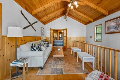 a living room with a couch and a table at Colibri Cabin - Walk to Lake and Trails in Big Bear Lake