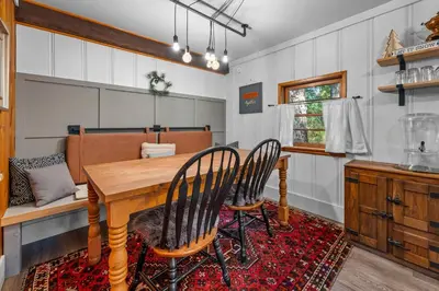 a dining room with a wooden table and chairs at Colibri Cabin - Walk to Lake and Trails in Big Bear Lake