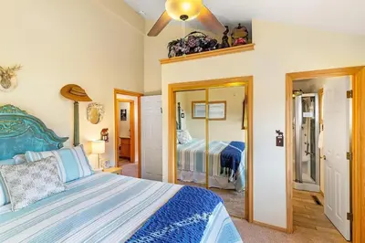a bedroom with a bed and a mirror at Lakeview Retreat - Walk to Lake, Close to Slopes in Big Bear Lake