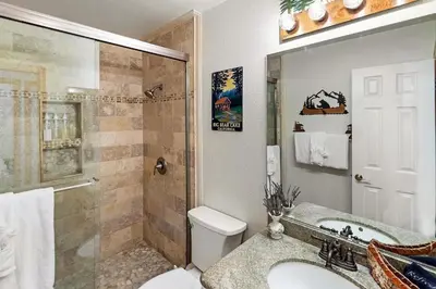 a bathroom with a toilet and a sink and a shower at Lakeview Retreat - Walk to Lake, Close to Slopes in Big Bear Lake