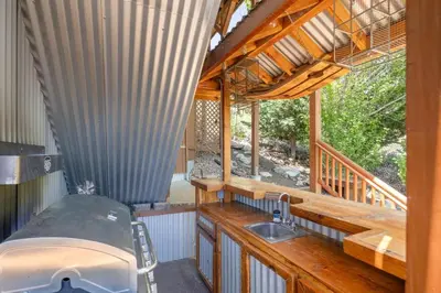 an outdoor kitchen with a sink in a house at Foster’s Cabin - Close to Lake and Slopes in Big Bear City