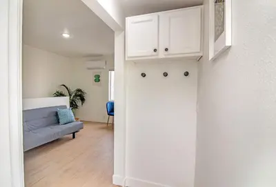 a living room with a couch and a white wall at Private Guesthouse Studio Near Echo Park in Los Angeles