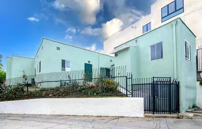 a blue building with a fence in front of it at Private Guesthouse Studio Near Echo Park in Los Angeles