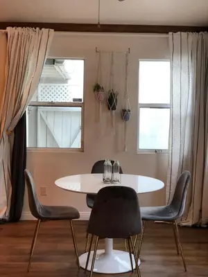 a dining room with a white table and chairs at LA Beach City Studio in Harbor City