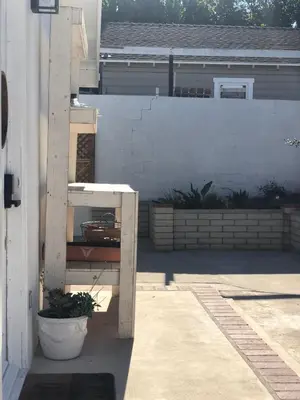 a patio with a white fence and a table at LA Beach City Studio in Harbor City