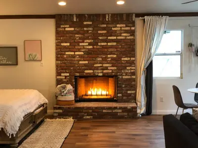 a bedroom with a brick fireplace in a room at LA Beach City Studio in Harbor City