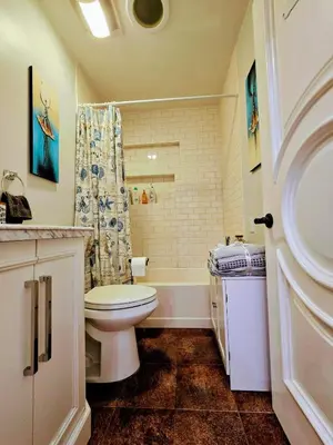a bathroom with a toilet and a shower at Entire Luxurious Vaulted Haven with Pool in Tarzana