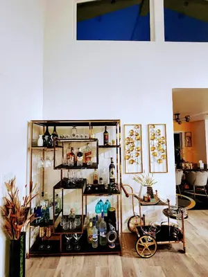 a room with a shelf with various items on it at Entire Luxurious Vaulted Haven with Pool in Tarzana